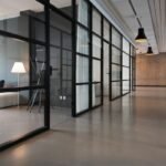 Bright modern office corridor with glass meeting rooms