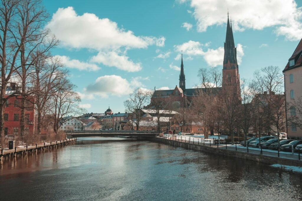 River running between historic buildings in a Swedish university town