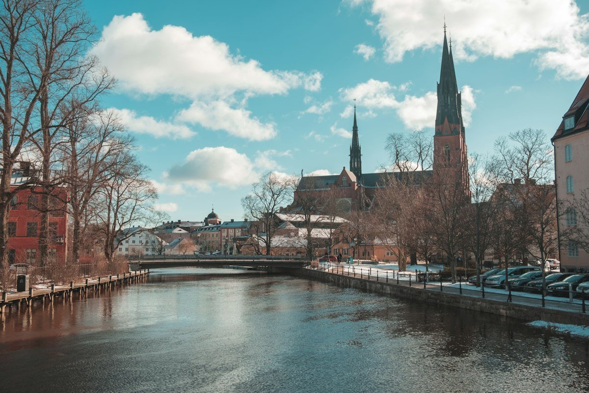 River running between historic buildings in a Swedish university town