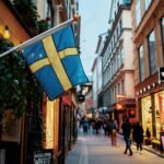 Swedish flags hanging over a street in Stockholm's old town