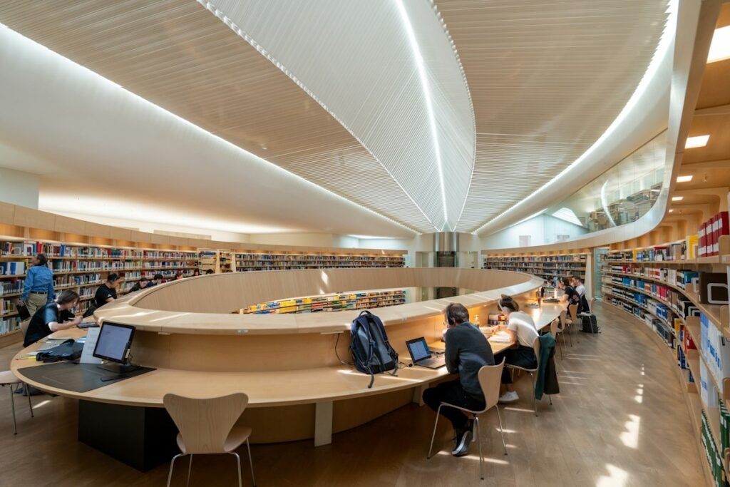 Students working in a bright modern university library